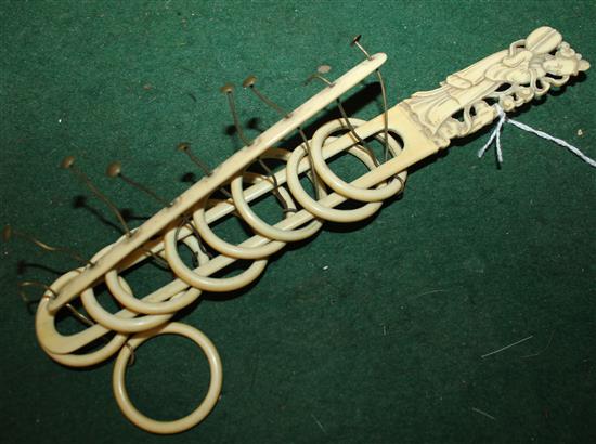 19C Chinese carved ivory bar and rings puzzle, with figural finial and brass pins